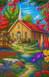 A stone church with red roof surrounded by colourful flowers, trees, and a small stream with a wooden bridge.