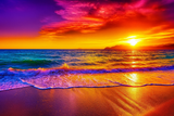 Vivid sunset over the ocean with colourful sky and waves.