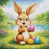 Cheerful bunny holding a colourful Easter egg in a meadow. Size - 40cm x 40cm