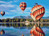 colourful hot air balloons reflecting on a lake with mountains in the background. Size - 40cm x 30cm