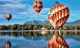 colourful hot air balloons reflecting on a lake with mountains in the background. Size - 50cm x 30cm