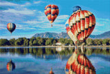 colourful hot air balloons reflecting on a lake with mountains in the background. Size - 60cm x 40cm