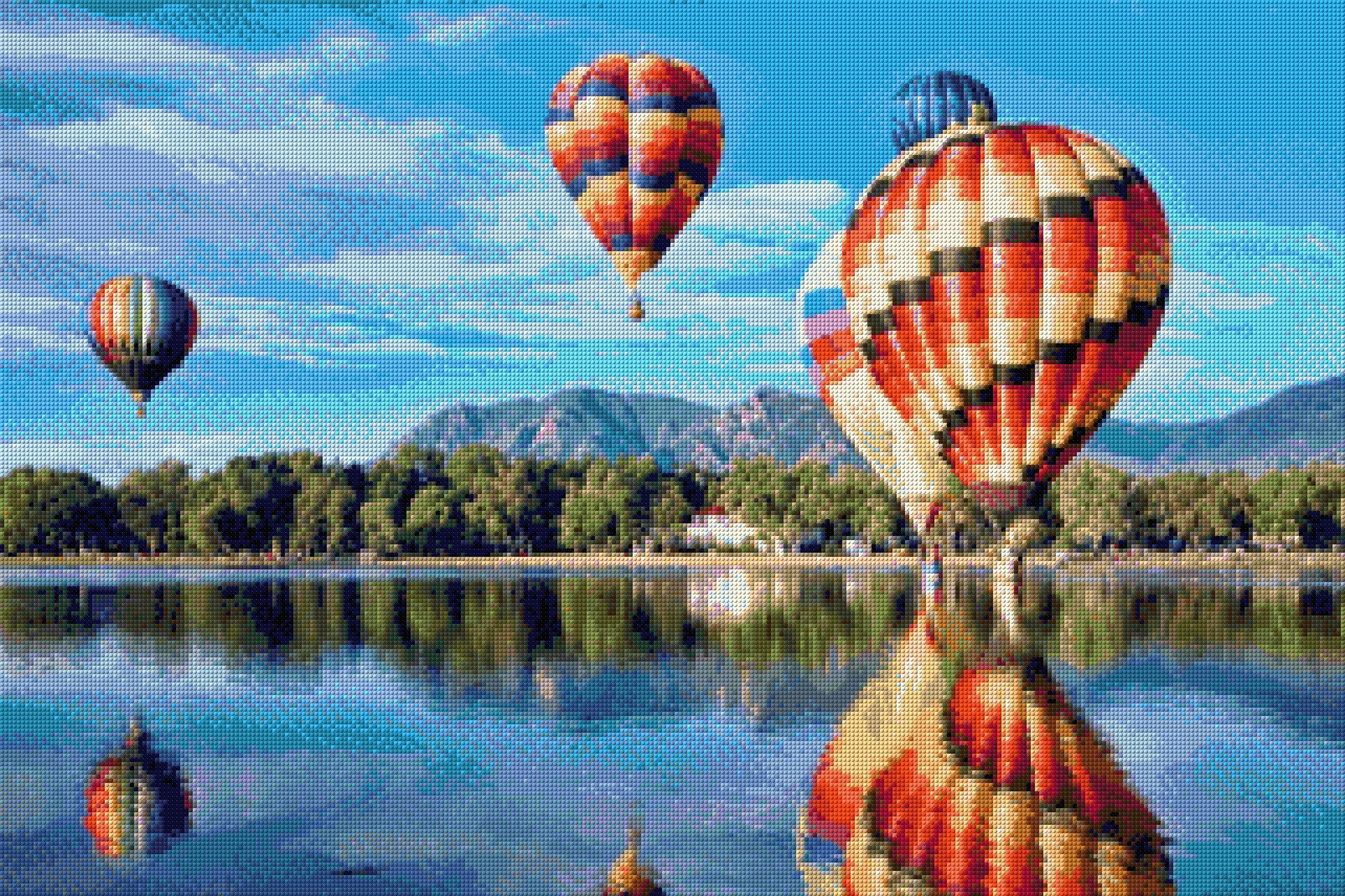 colourful hot air balloons reflecting on a lake with mountains in the background. Size - 90cm x 60cm