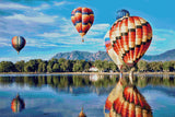 colourful hot air balloons reflecting on a lake with mountains in the background. Size - 90cm x 60cm