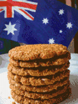 Stack of Anzac biscuits with Australian flag in background. Size - 30cm x 40cm
