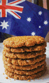 Stack of Anzac biscuits with Australian flag in background. Size - 30cm x 50cm