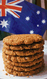 Stack of Anzac biscuits with Australian flag in background. Size - 30cm x 50cm