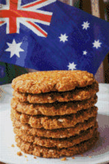 Stack of Anzac biscuits with Australian flag in background. Size - 40cm x 60cm