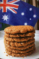Stack of Anzac biscuits with Australian flag in background. Size - 60cm x 90cm