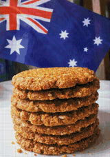 Stack of Anzac biscuits with Australian flag in background. Size - 70cm x 100cm