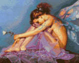 A fairy with colourful wings sits, holding a flower, on a lavender cloth. Size - 50cm x 40cm