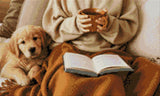 Person holding a mug with a puppy and an open book on a blanket. Size - 50cm x 30cm